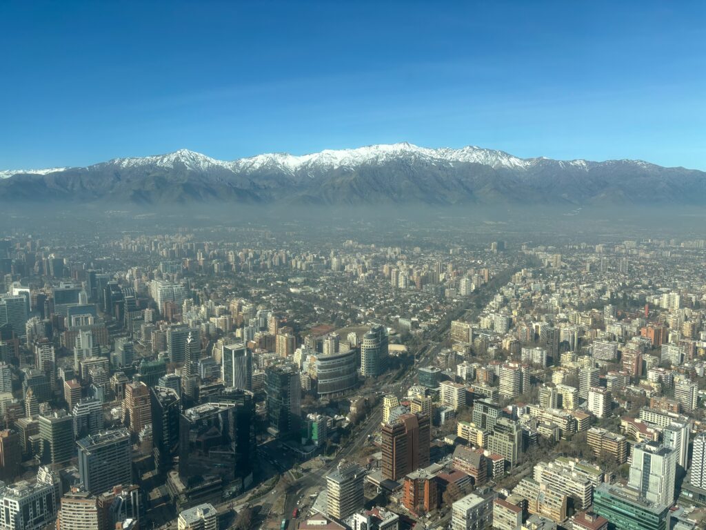 a city with snow covered mountains in the background