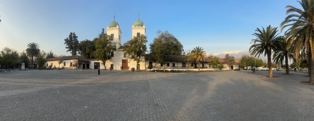 a building with two towers and trees