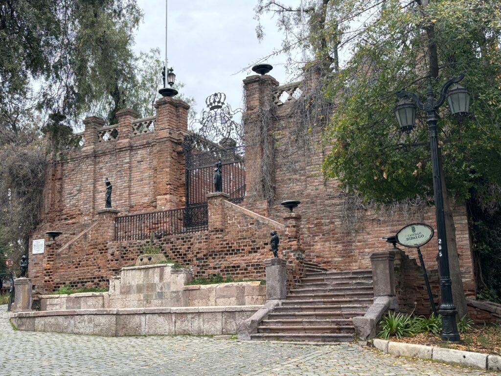 a brick building with stairs and trees