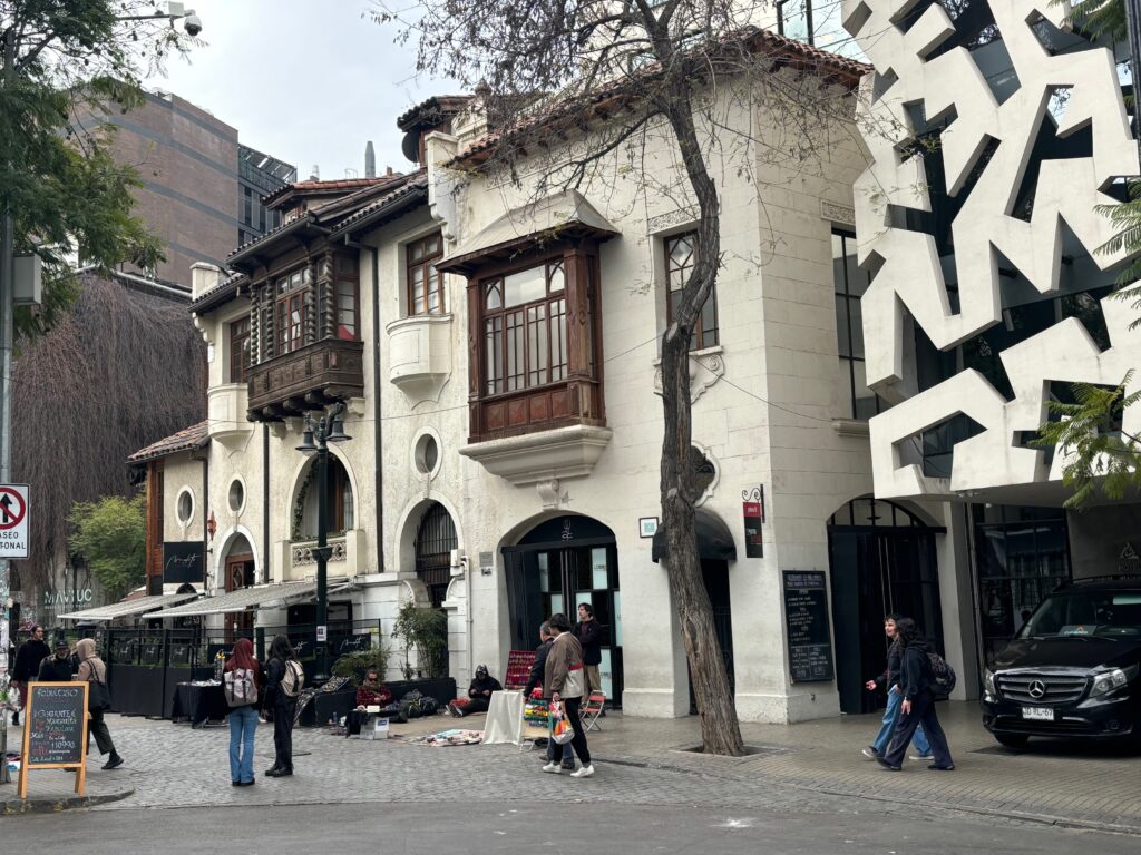 a group of people walking in front of a building