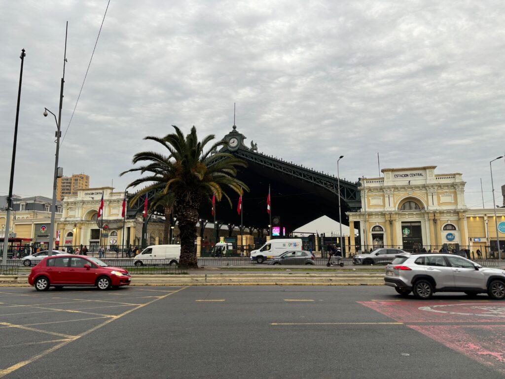 a street with cars and a building with a clock on it