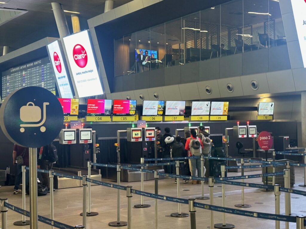 people standing in a line at an airport