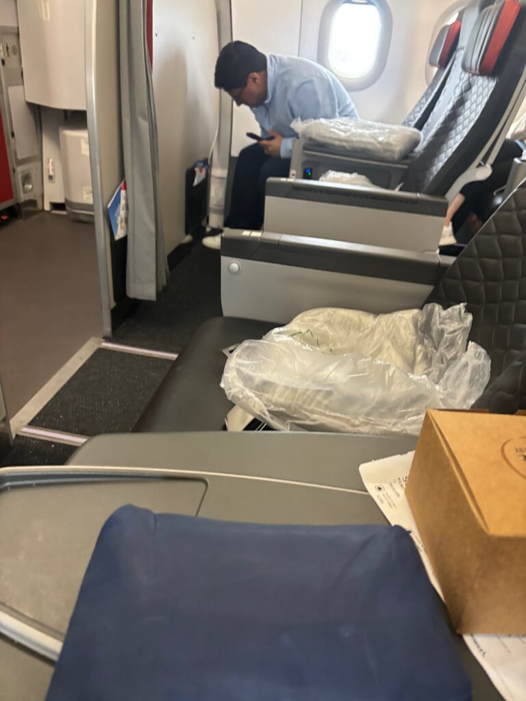 a man sitting on a chair in an airplane