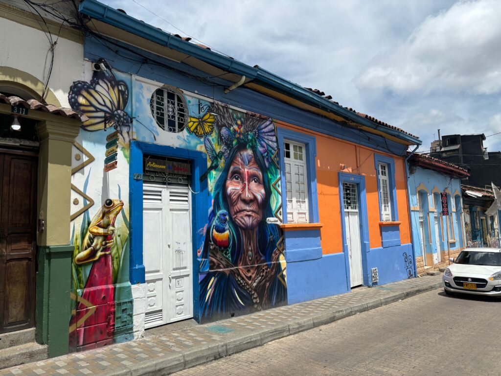 a colorful building with a mural on the side