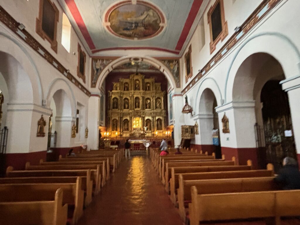 a church with pews and a gold object