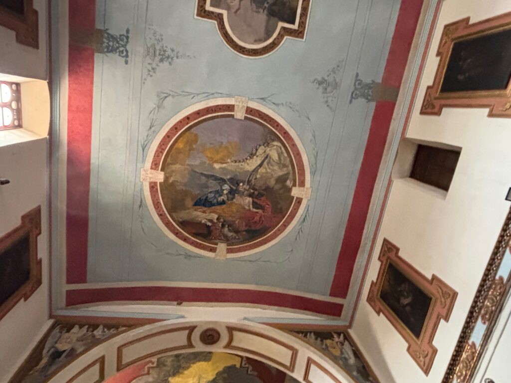 a painted ceiling with a painting on the ceiling