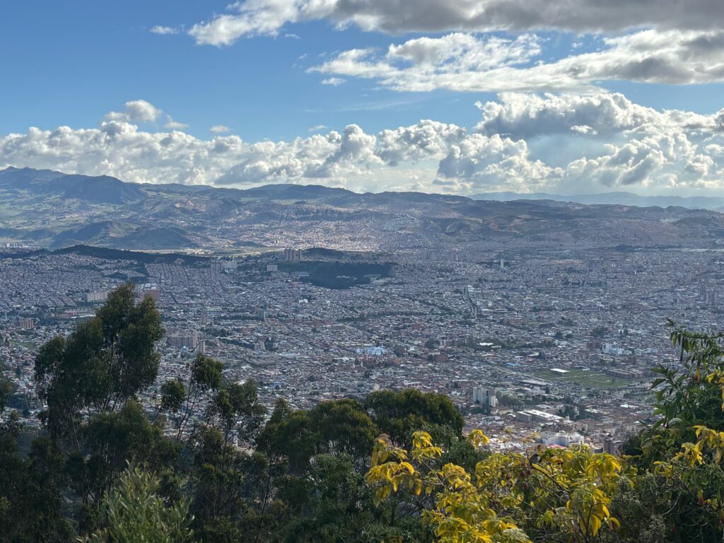 a city landscape with trees and clouds