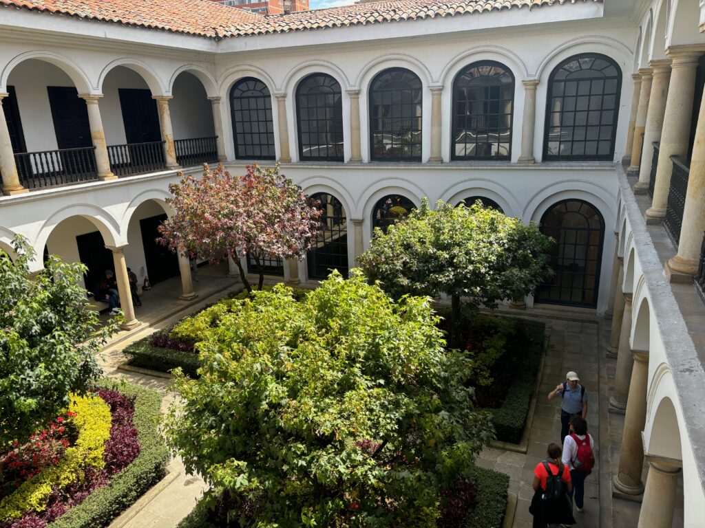 a group of people walking in a courtyard