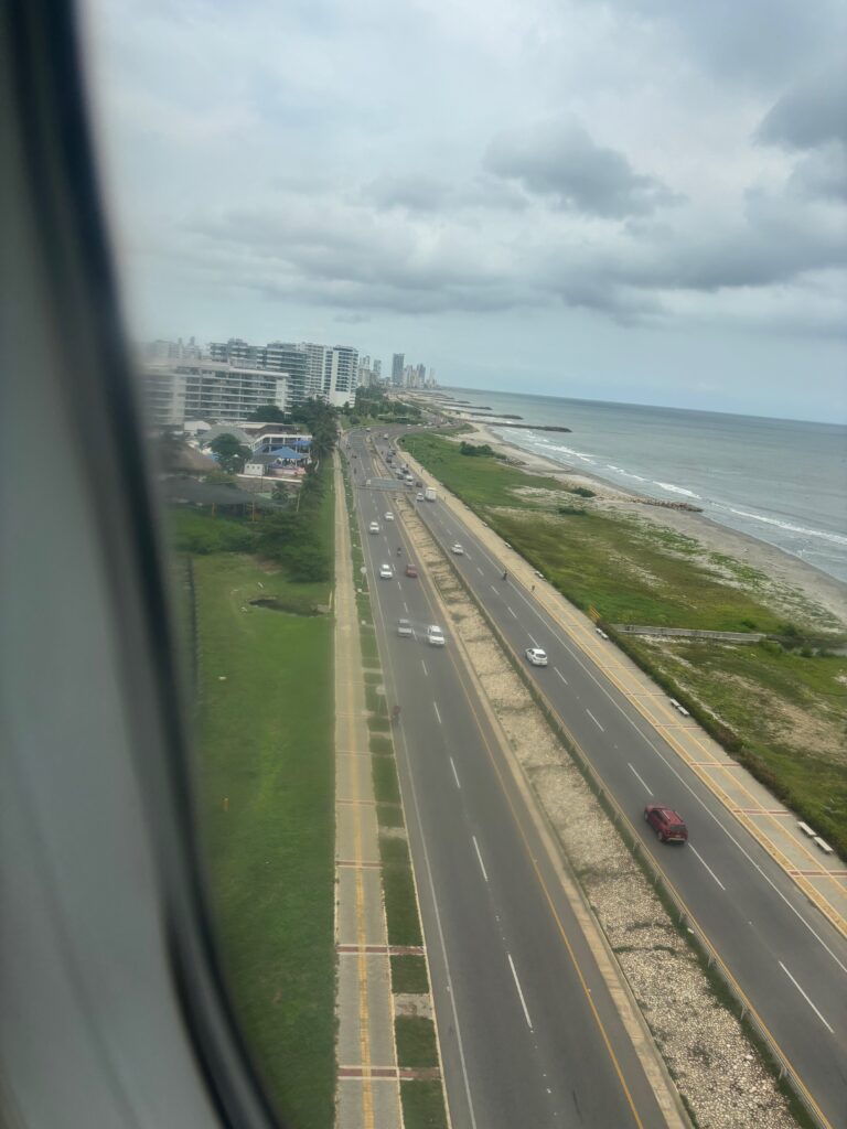 a road with cars on it and a body of water