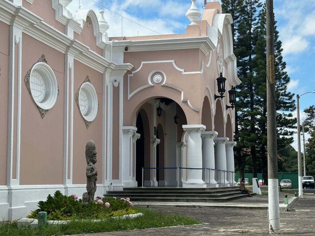 a building with columns and a stone walkway