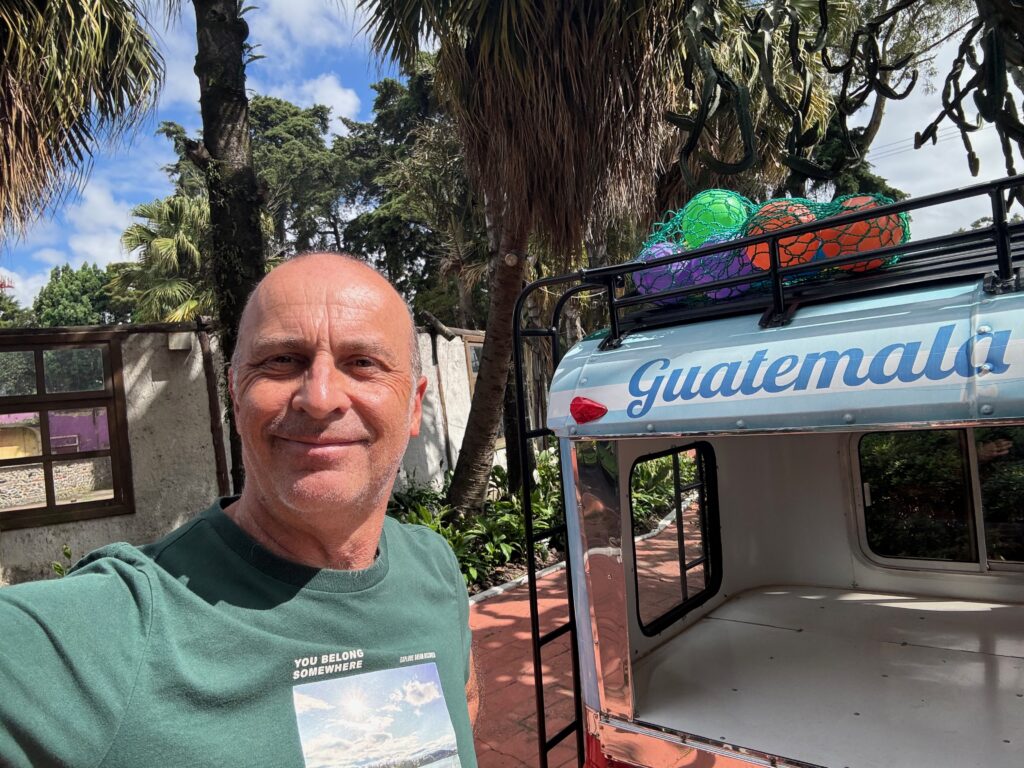 a man taking a selfie in front of a small ice cream truck