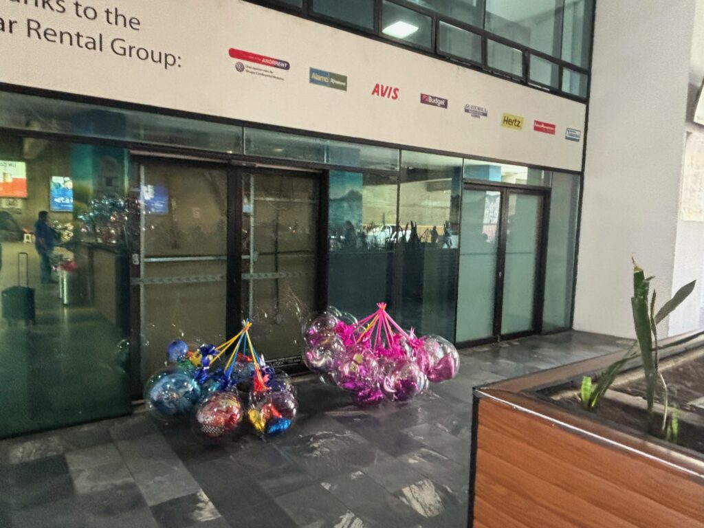 a bunch of balloons in front of a building