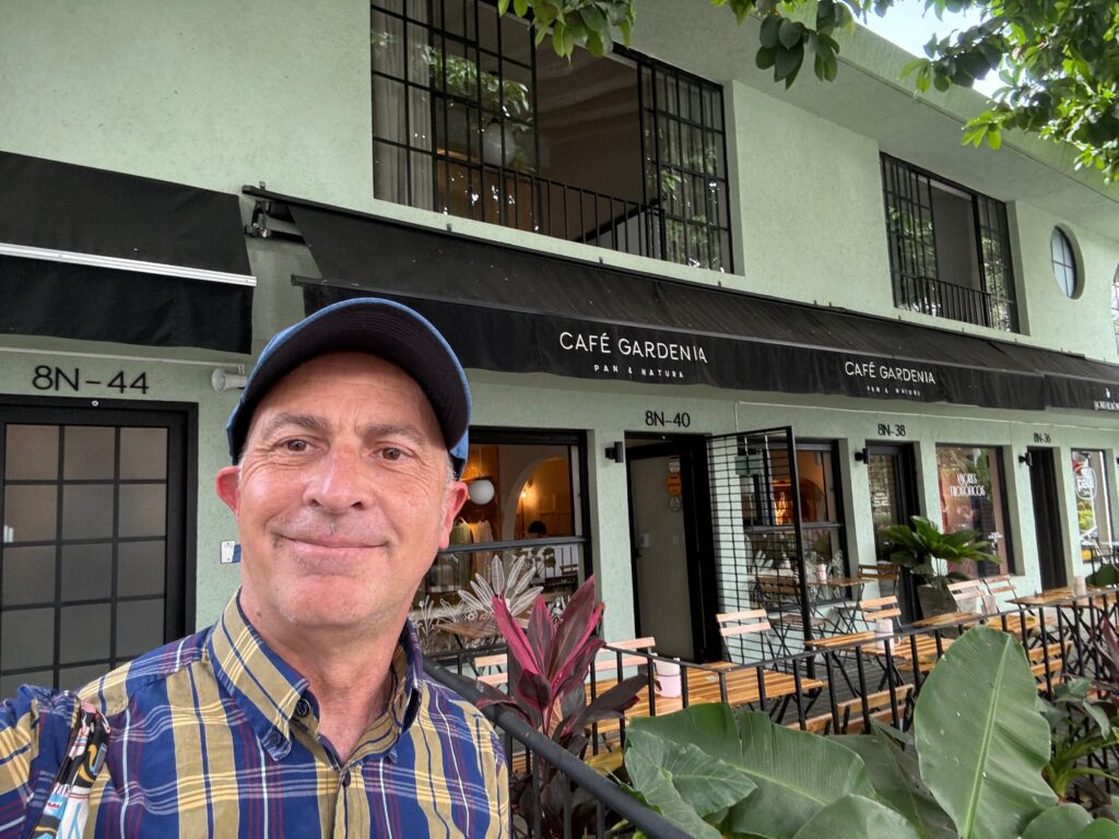 a man taking a selfie in front of a building