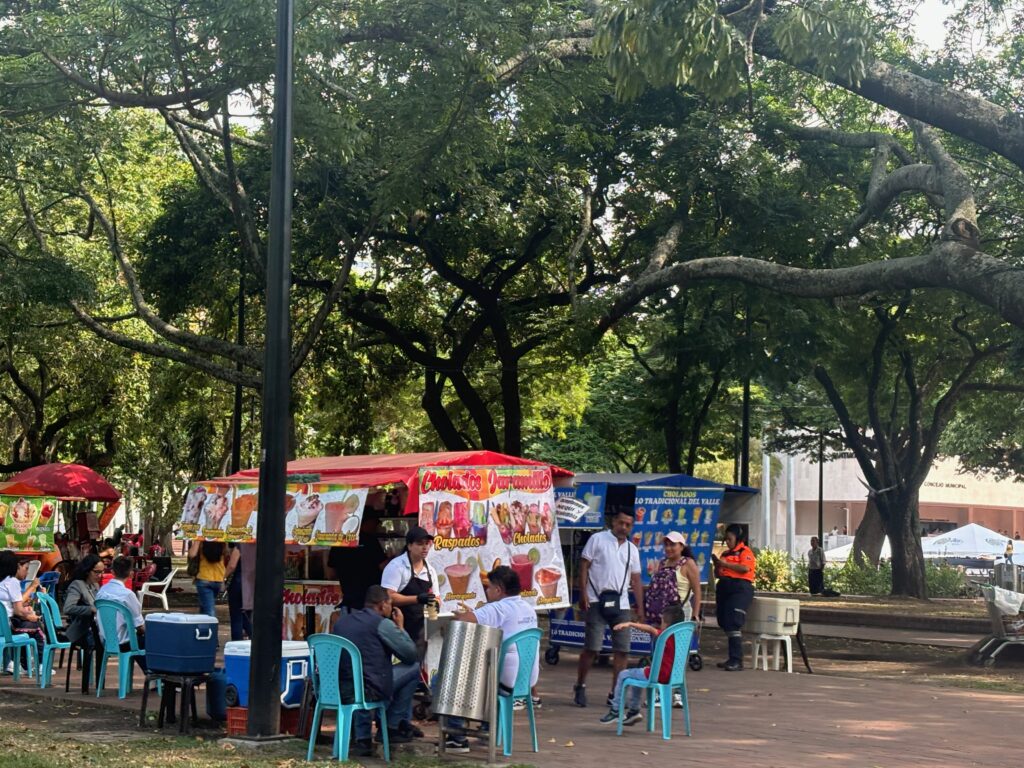 a group of people outside a food stand