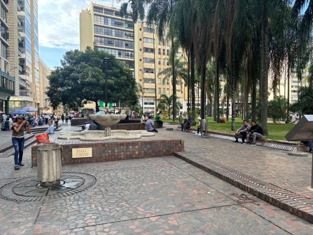 people sitting on a bench in a park