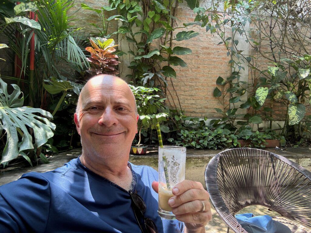 a man holding a glass of liquid