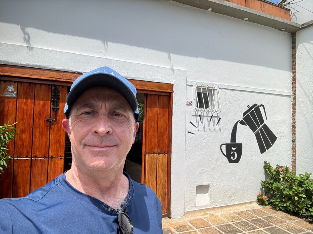 a man taking a selfie in front of a building