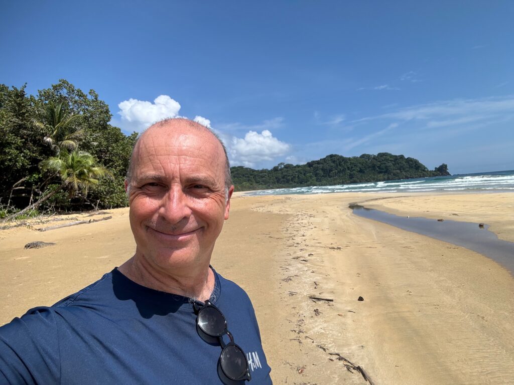 a man taking a selfie on a beach