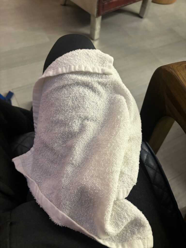 a white towel on a black chair