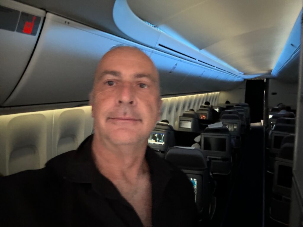 a man taking a selfie in an airplane