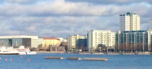 a body of water with buildings in the background