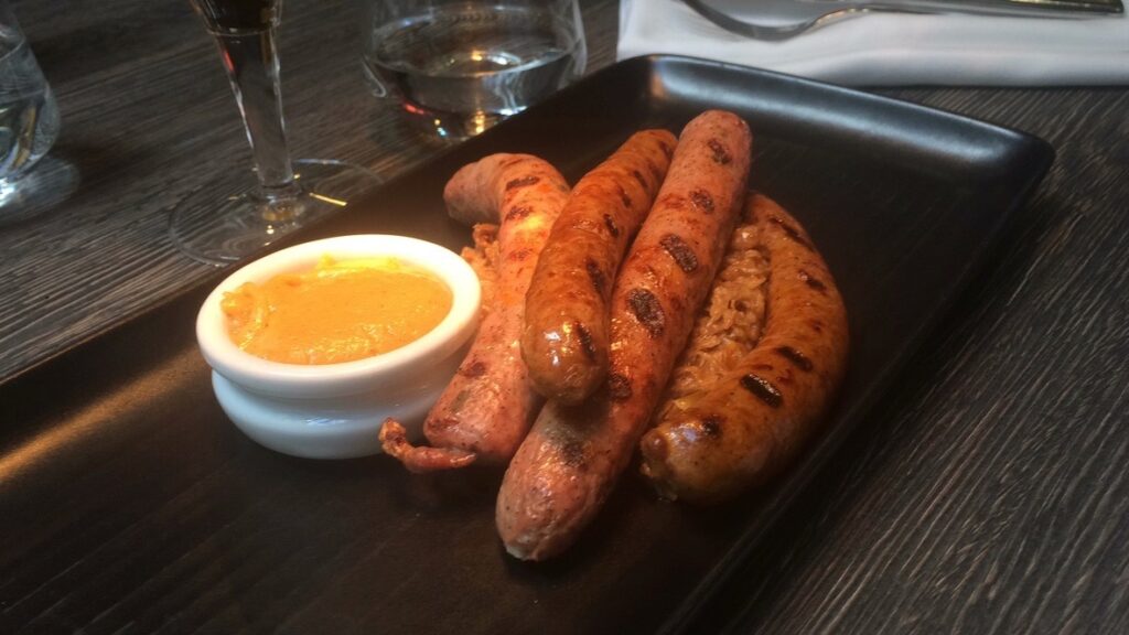 a plate of sausages and dip