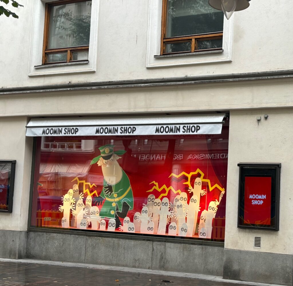 a store front with a window with a green leprechaun and red lightning