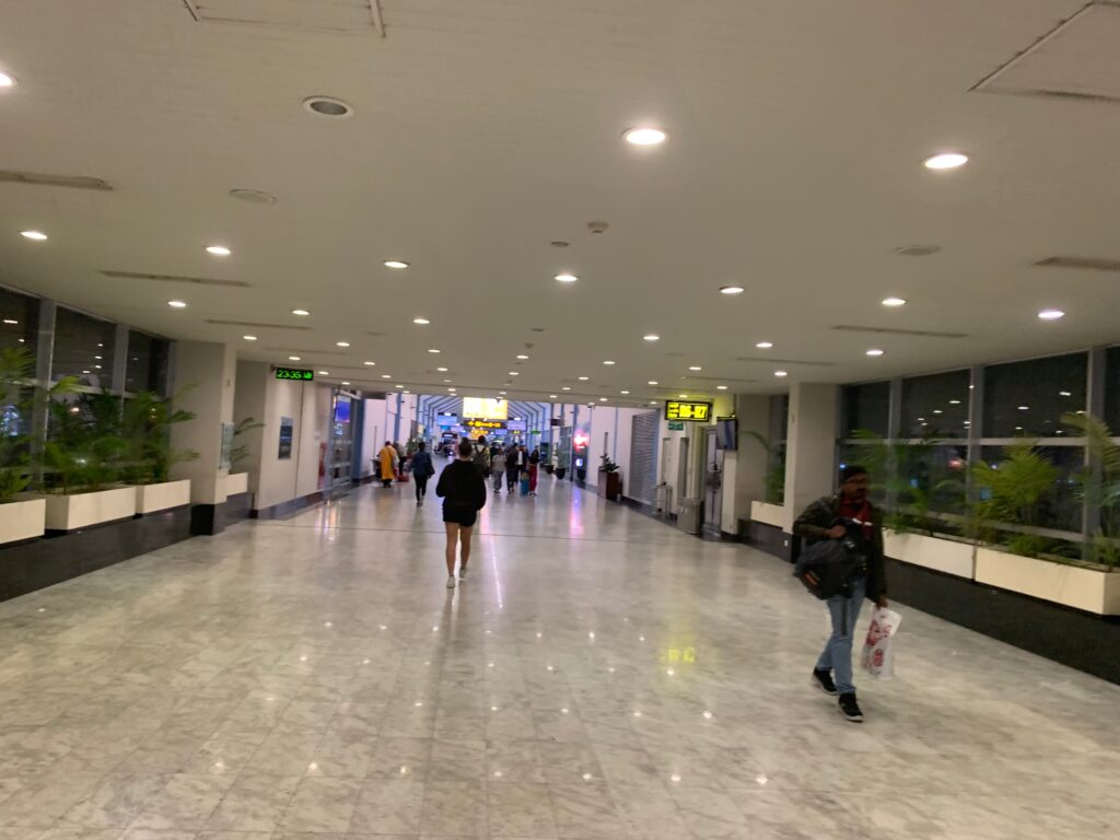 a group of people walking in a large hallway