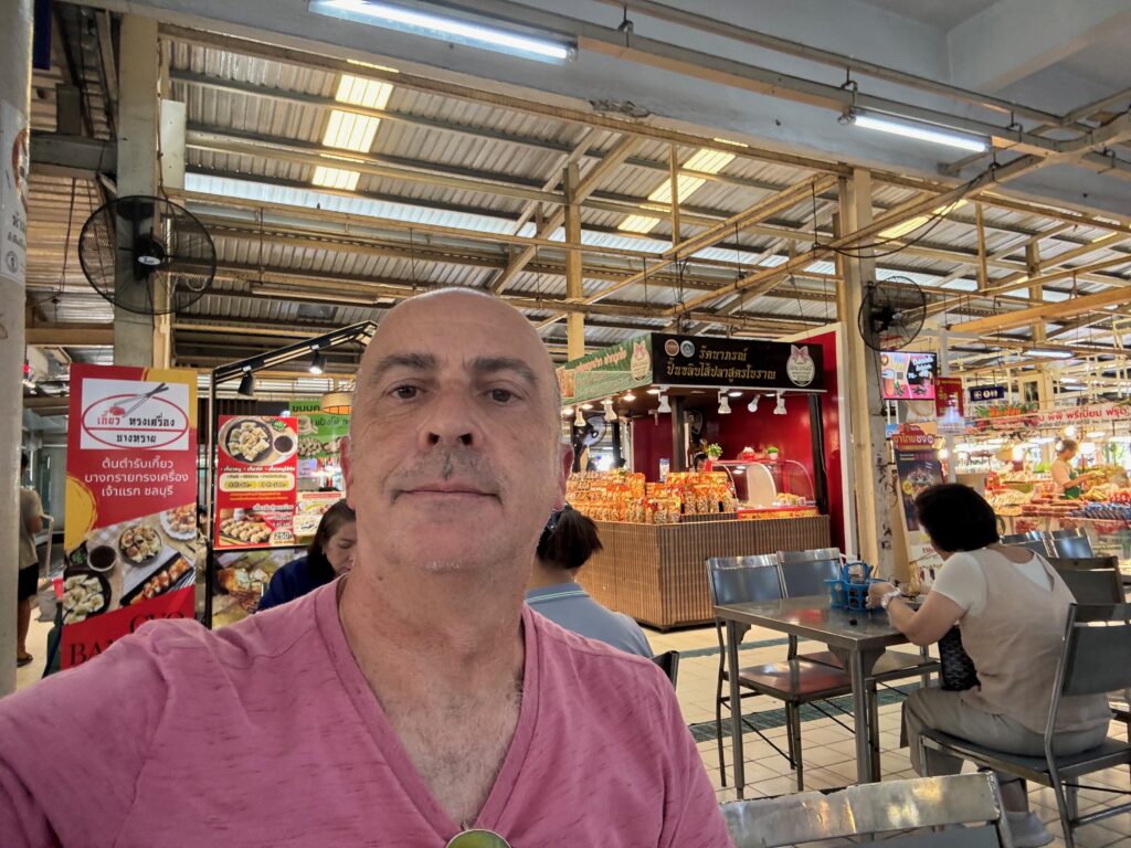 a man taking a selfie in a food court