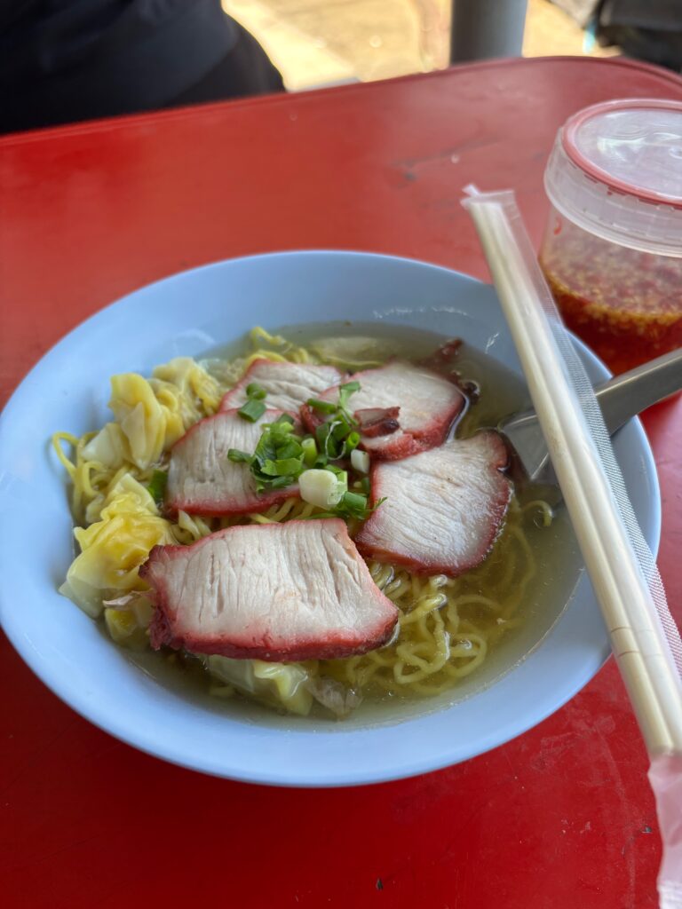 a bowl of noodles with meat and vegetables