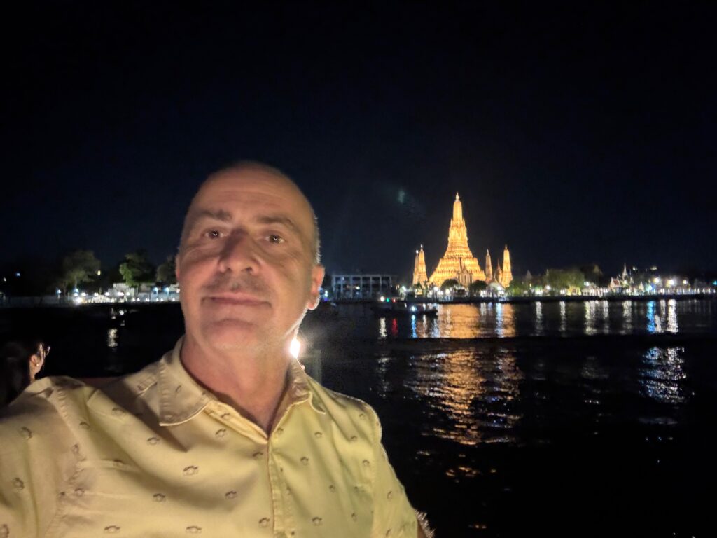 a man taking a selfie in front of a building