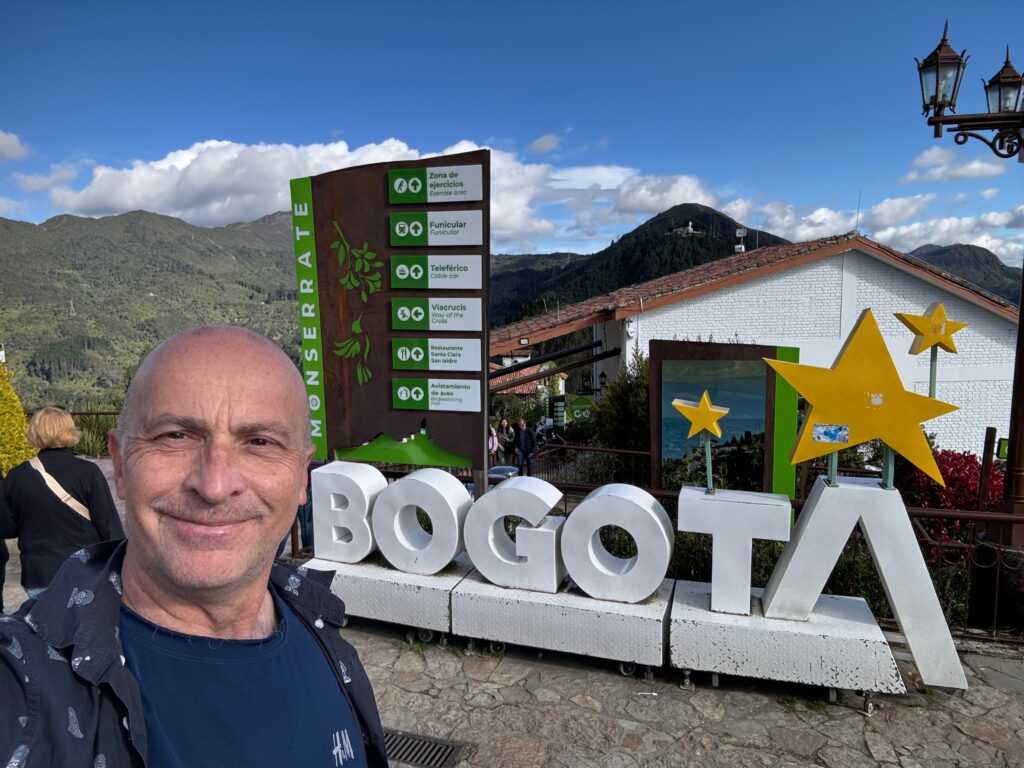 a man taking a selfie in front of a sign