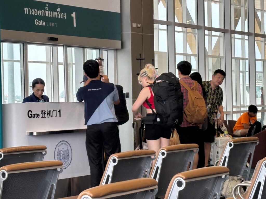 people standing in a line at a gate