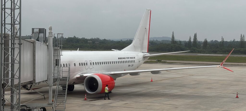 a white airplane with red and white stripes on the side