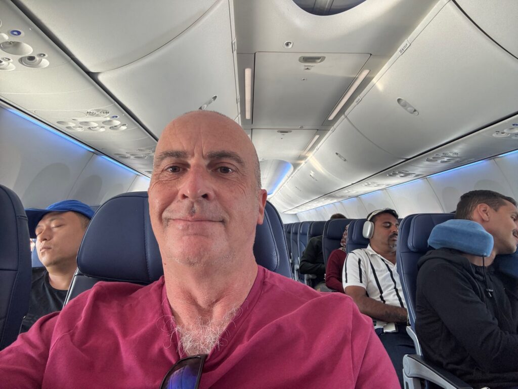 a man taking a selfie in an airplane