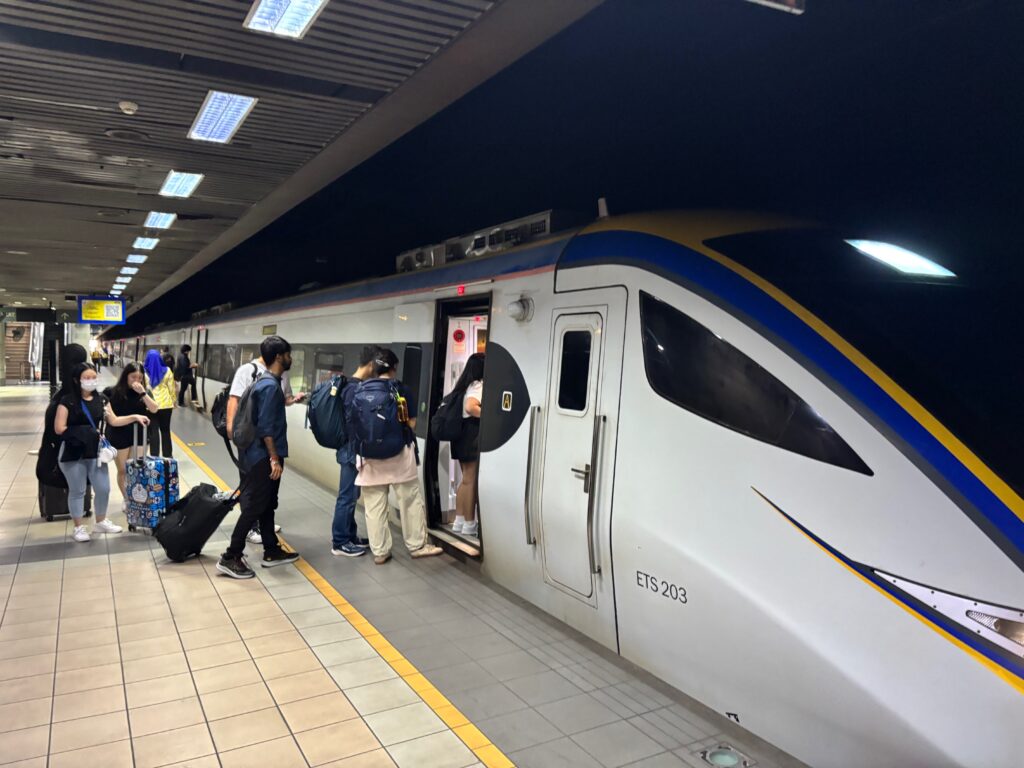 people standing next to a train