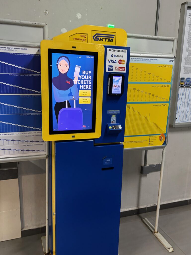 a machine with a screen and a blue and yellow sign