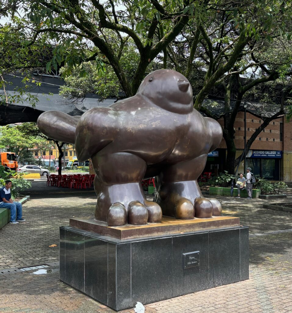 a statue of a bird on a pedestal