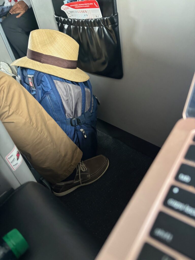 a backpack and hat on a seat