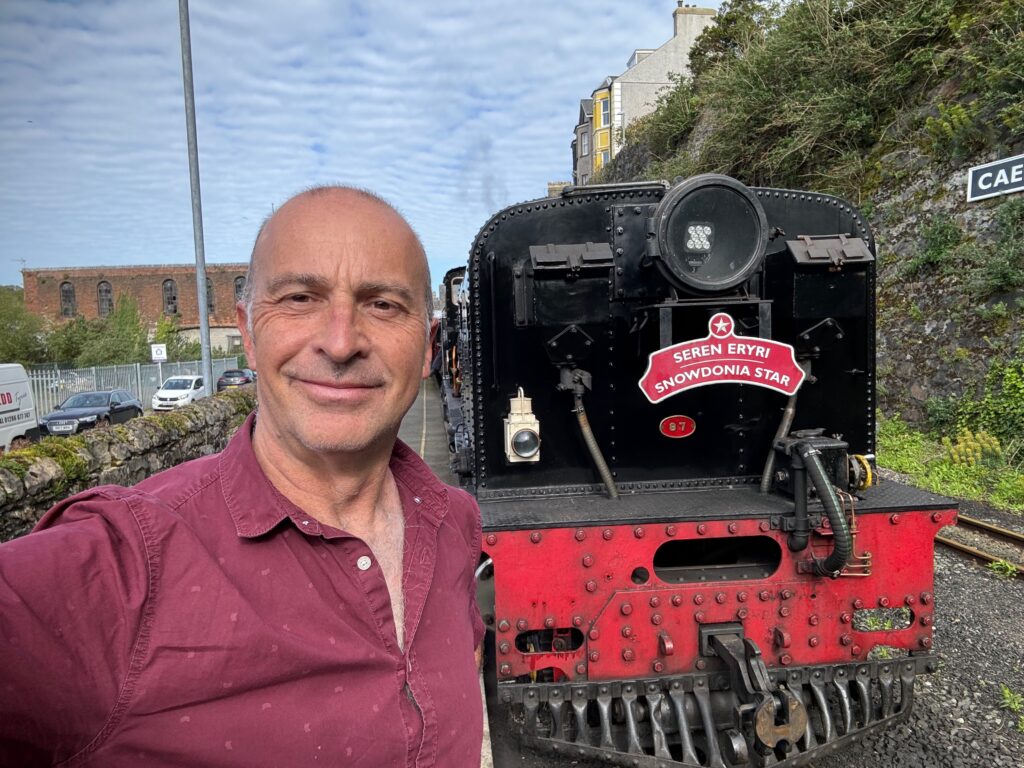 a man standing next to a train