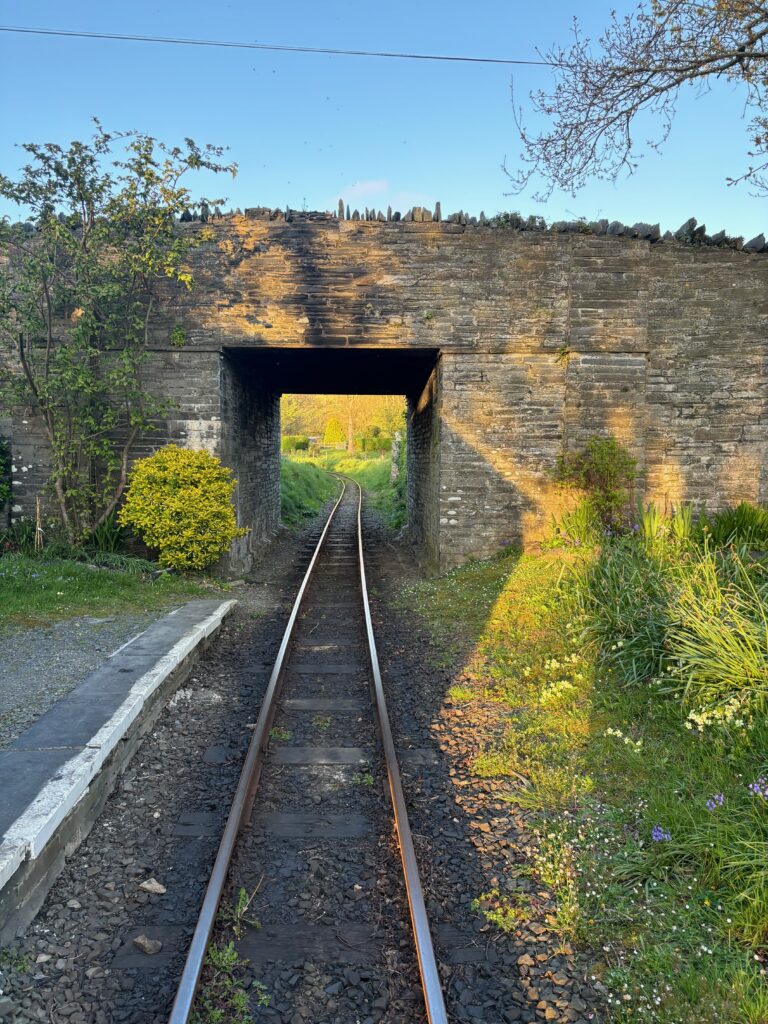 a train tracks going through a stone bridge