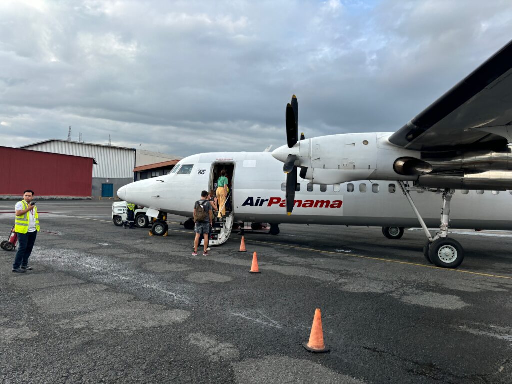 a plane with people boarding