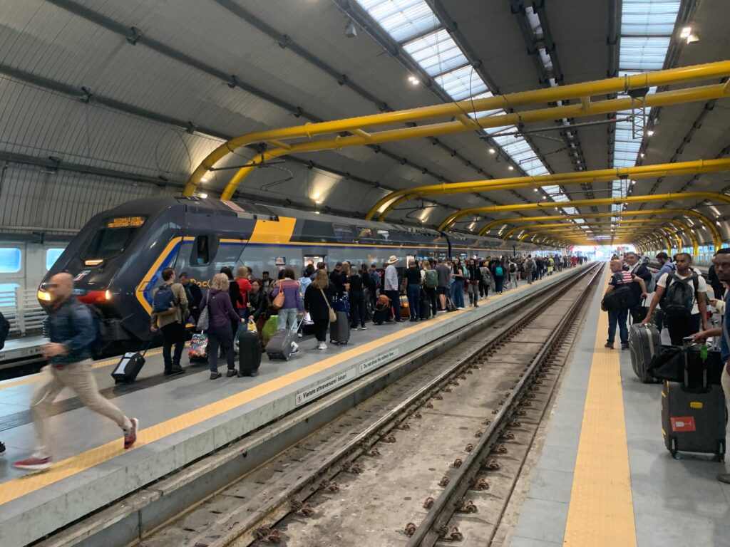 a group of people standing on a train platform