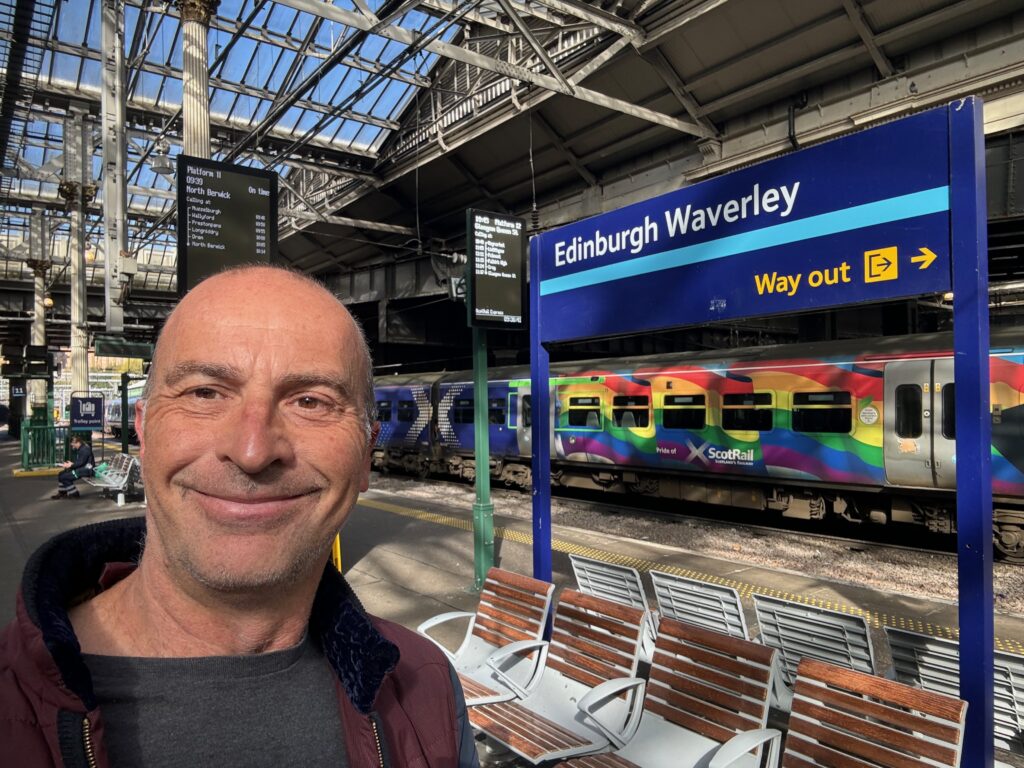 a man taking a selfie in a train station