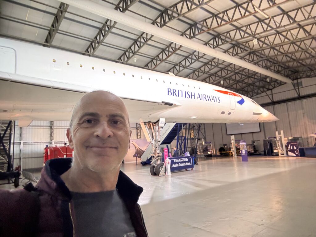 a man taking a selfie in a hangar