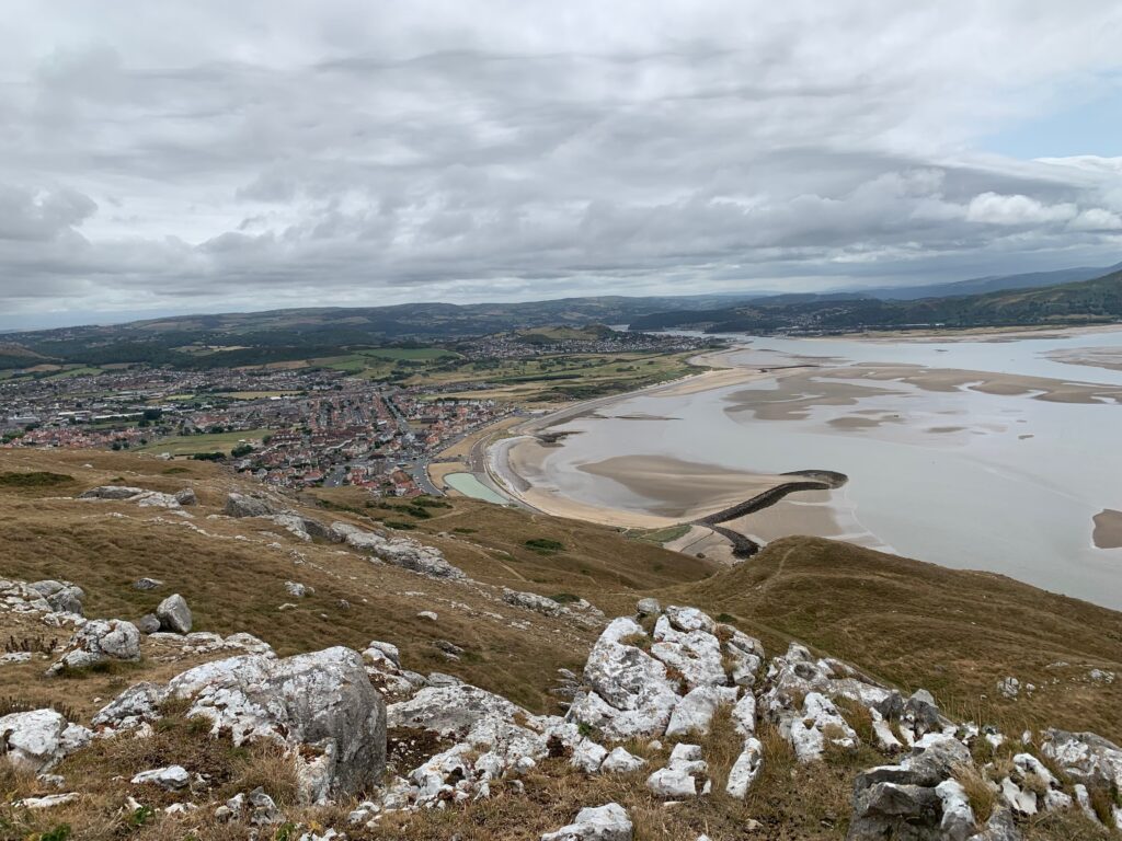 a landscape with a body of water and a city