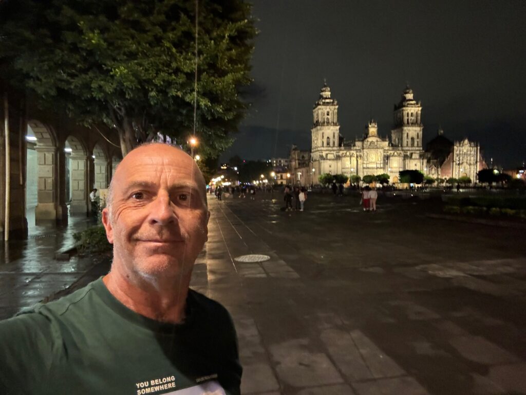 a man taking a selfie in front of a building