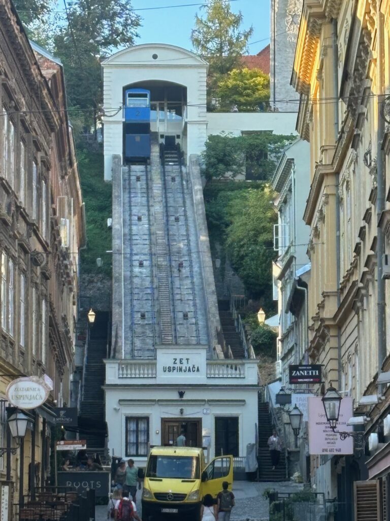 a blue train going up a hill