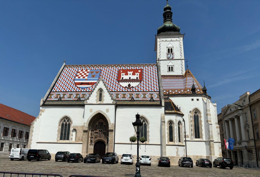 a white building with a tower and a flag on it