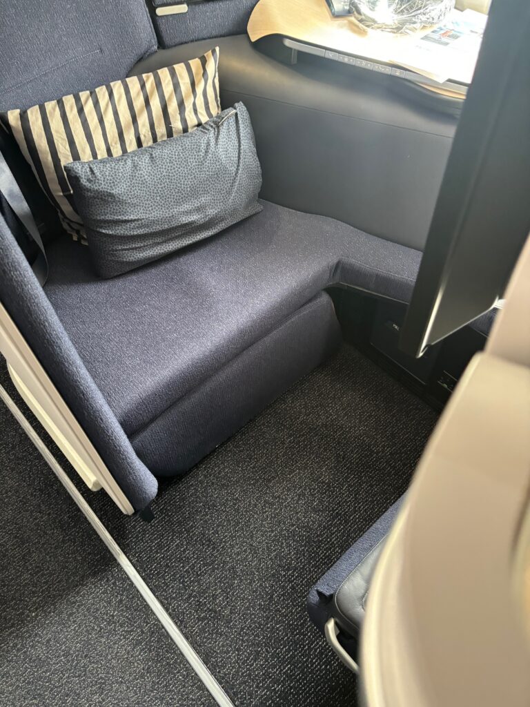 a seat with a pillow and a cushion on it